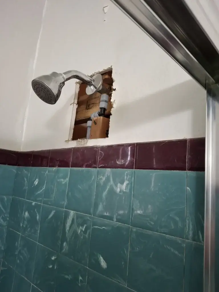 Access hole cut around shower valve