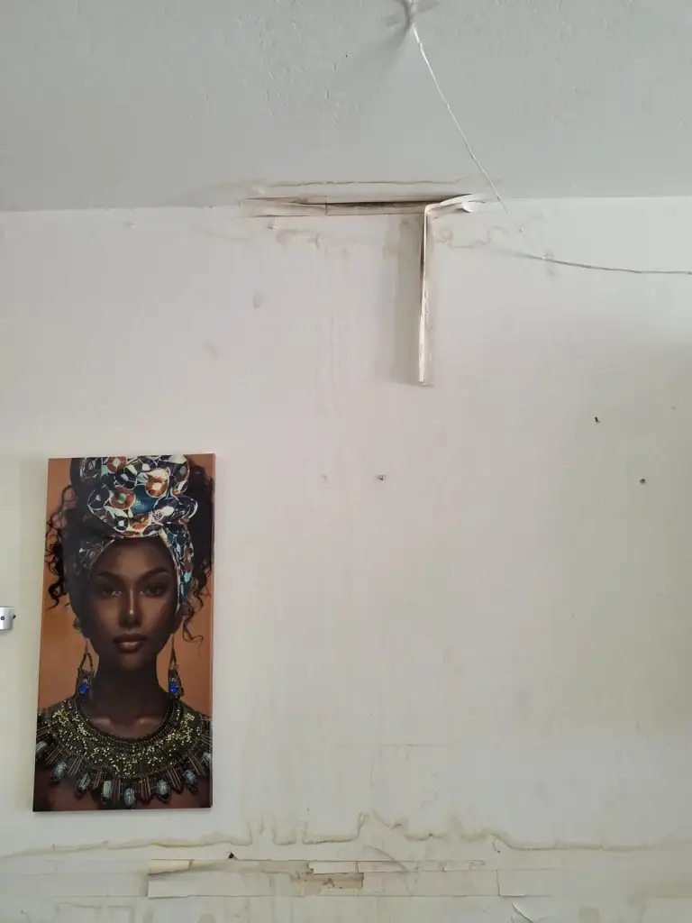 Peeling drywall tape at ceiling