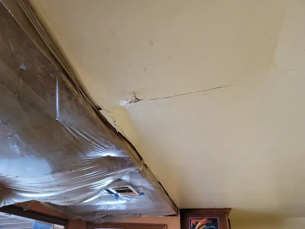 Water damaged ceiling with plastic sheeting